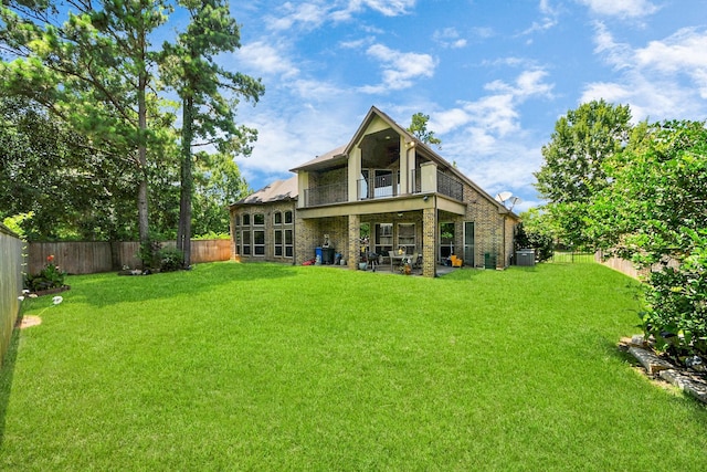 102 Stonecrop Pl, Montgomery, TX 77316 - rear view of house featuring a fenced backyard, a balcony, brick siding, and a patio