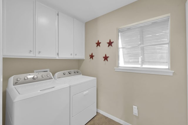 2117 Nantucket Dr, Houston, TX 77057 - washroom featuring independent washer and dryer, cabinet space, and light tile patterned floors
