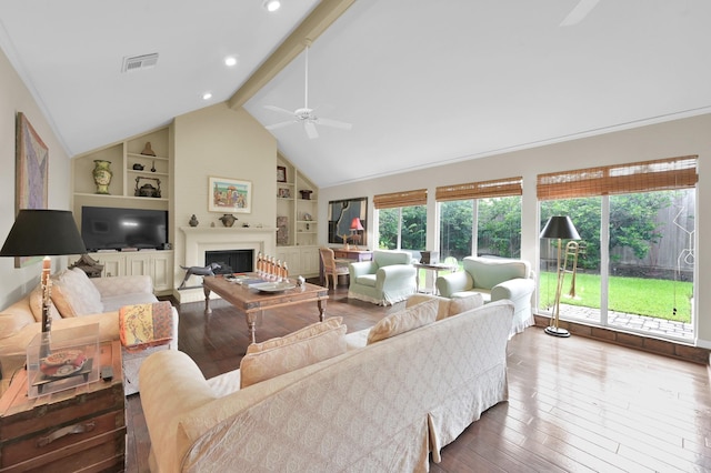 2117 Nantucket Dr, Houston, TX 77057 - living room featuring built in shelves, hardwood / wood-style flooring, ceiling fan, and a fireplace