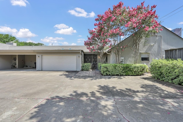 2117 Nantucket Dr, Houston, TX 77057 - view of front of home featuring an attached garage, stucco siding, and driveway