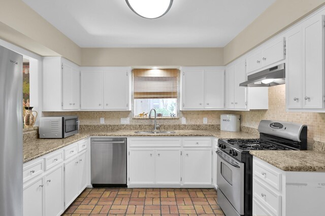 2117 Nantucket Dr, Houston, TX 77057 - kitchen featuring stainless steel appliances, under cabinet range hood, decorative backsplash, and white cabinets