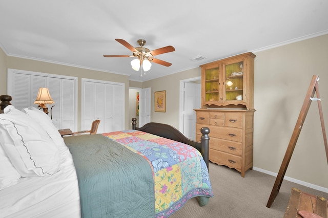 2117 Nantucket Dr, Houston, TX 77057 - bedroom featuring two closets, light colored carpet, ornamental molding, and a ceiling fan