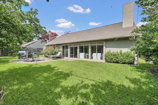 2117 Nantucket Dr, Houston, TX 77057 - rear view of house featuring a patio, a chimney, stucco siding, and a shingled roof