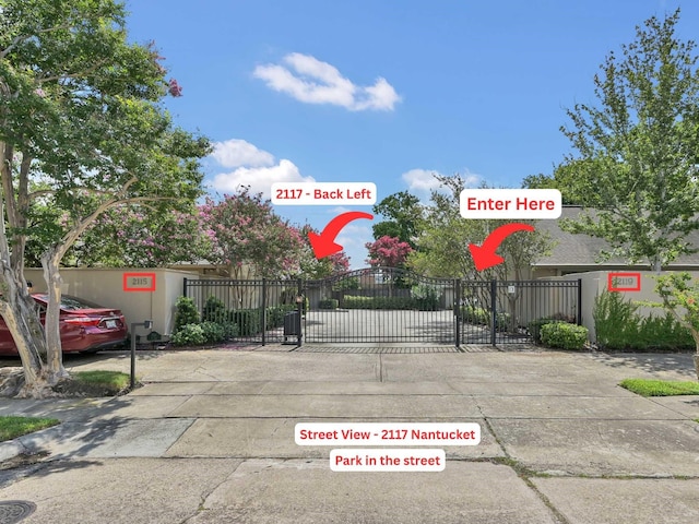 2117 Nantucket Dr, Houston, TX 77057 - view of concrete street featuring a gate and a gated entry