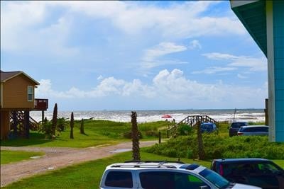 123 Sandpiper Ave, Surfside Beach, TX 77541 - view of parking / parking lot featuring a water view