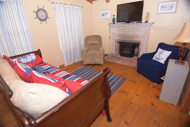 123 Sandpiper Ave, Surfside Beach, TX 77541 - living room with hardwood / wood-style floors and a brick fireplace
