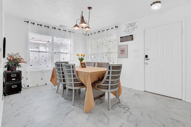 29207 Legends Hill Dr, Spring, TX 77386 - dining area featuring marble look tile flooring and a textured ceiling