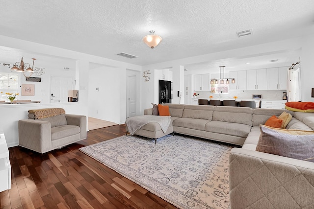 29207 Legends Hill Dr, Spring, TX 77386 - living area with a chandelier, dark wood-style floors, and a textured ceiling