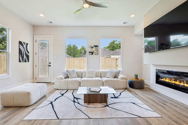 3720 Nathaniel Brown St, Houston, TX 77021 - living area with wood finished floors, a glass covered fireplace, a ceiling fan, and recessed lighting
