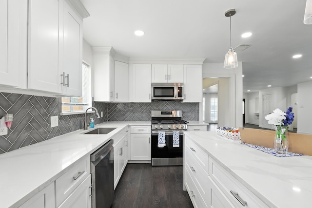 9226 Kapri Ln, Houston, TX 77025 - kitchen featuring stainless steel appliances, backsplash, white cabinets, and recessed lighting