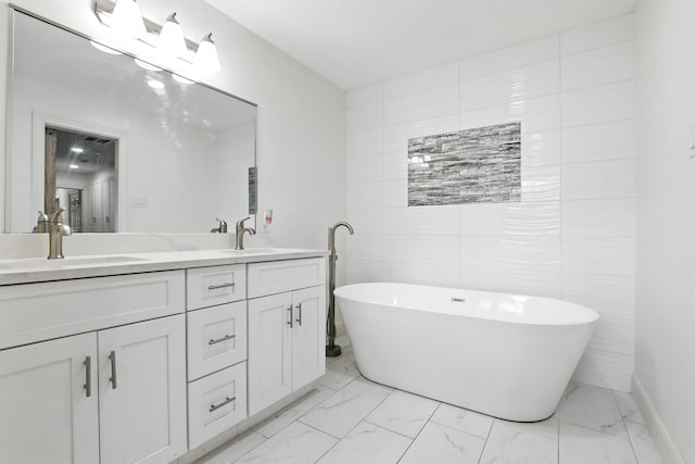 9226 Kapri Ln, Houston, TX 77025 - full bath with marble finish flooring, double vanity, a soaking tub, and tile walls