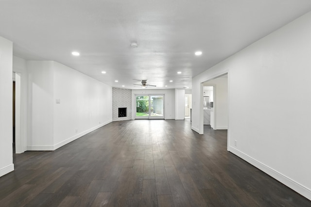 9226 Kapri Ln, Houston, TX 77025 - unfurnished living room featuring a ceiling fan, dark wood finished floors, recessed lighting, and a fireplace