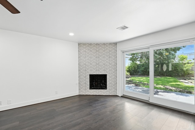 9226 Kapri Ln, Houston, TX 77025 - unfurnished living room with plenty of natural light, dark wood-style floors, a tile fireplace, recessed lighting, and ceiling fan