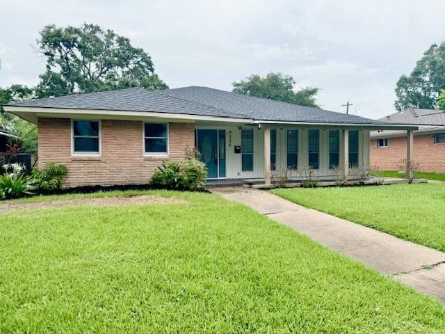 9226 Kapri Ln, Houston, TX 77025 - single story home featuring a front yard, brick siding, and covered porch