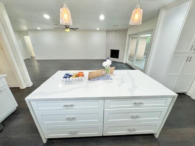 9226 Kapri Ln, Houston, TX 77025 - kitchen with white cabinets, ceiling fan, recessed lighting, open floor plan, and pendant lighting