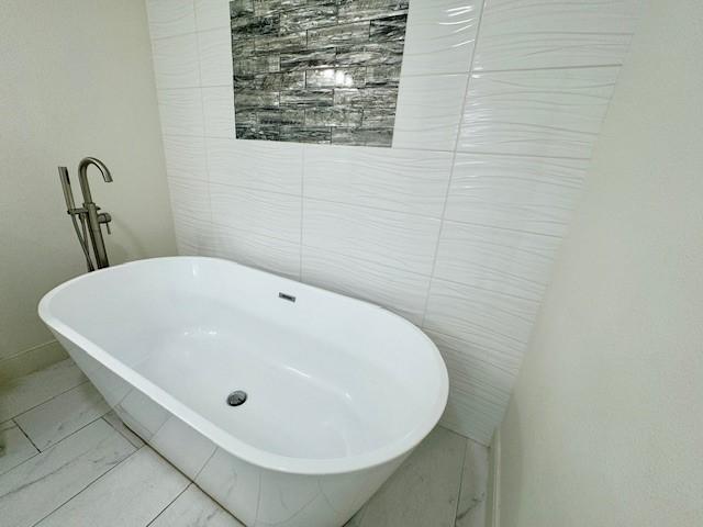 9226 Kapri Ln, Houston, TX 77025 - bathroom with a freestanding tub