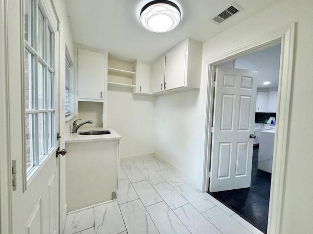 9226 Kapri Ln, Houston, TX 77025 - laundry room featuring light marble finish floors and washer / dryer