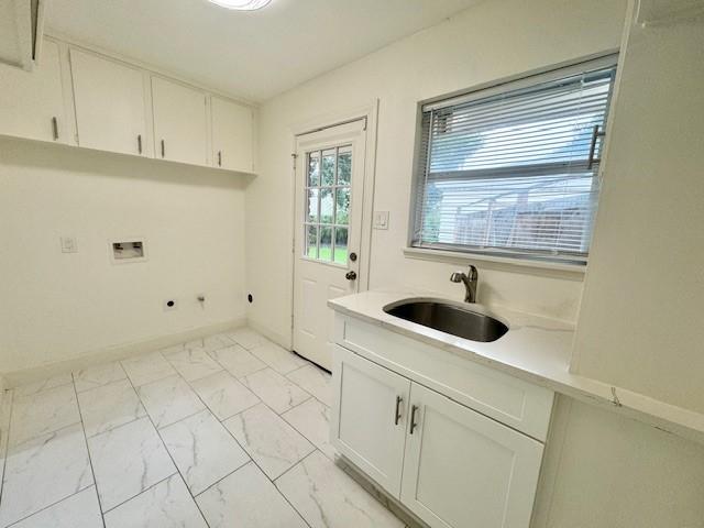 9226 Kapri Ln, Houston, TX 77025 - washroom featuring light marble finish floors, washer hookup, cabinet space, and electric dryer hookup