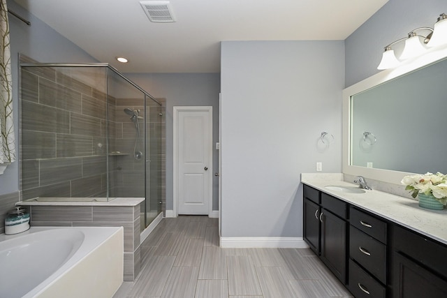 20202 Sienna Bluff Dr, Cypress, TX 77433 - full bath with vanity, a bath, a shower stall, and recessed lighting