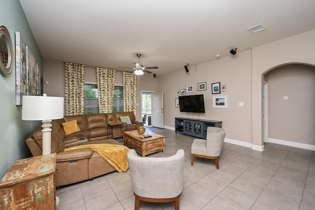 20202 Sienna Bluff Dr, Cypress, TX 77433 - tiled living room with arched walkways and a ceiling fan