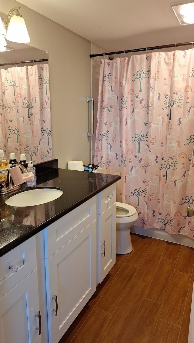 7510 Hornwood, Houston, TX 77036 - full bathroom with vanity, wood finished floors, and curtained shower