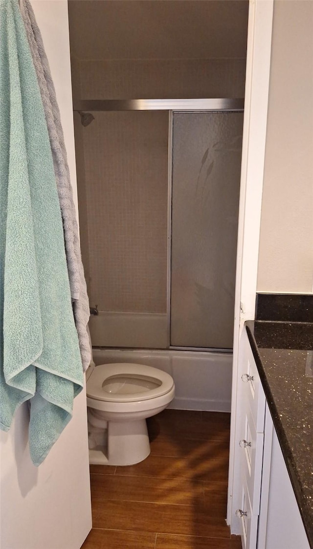 7510 Hornwood, Houston, TX 77036 - bathroom with wood finished floors, bath / shower combo with glass door, and vanity