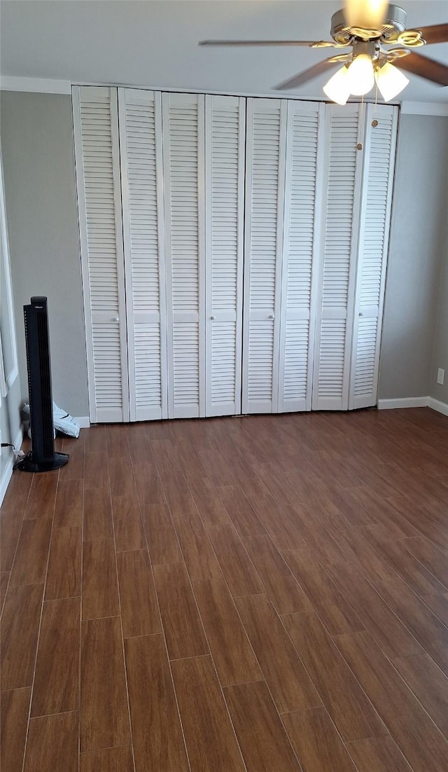 7510 Hornwood, Houston, TX 77036 - unfurnished bedroom with dark wood finished floors and ceiling fan