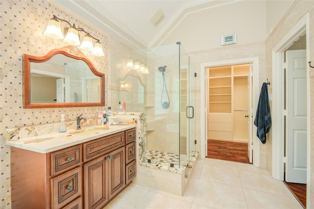 22315 Claysprings Ln, Katy, TX 77450 - full bath featuring vaulted ceiling, a shower stall, double vanity, tile patterned floors, and a spacious closet