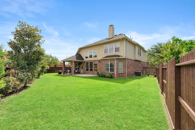 9523 Sapphire Hill Ln, Katy, TX 77494 - rear view of house with brick siding, a patio area, a chimney, and a fenced backyard