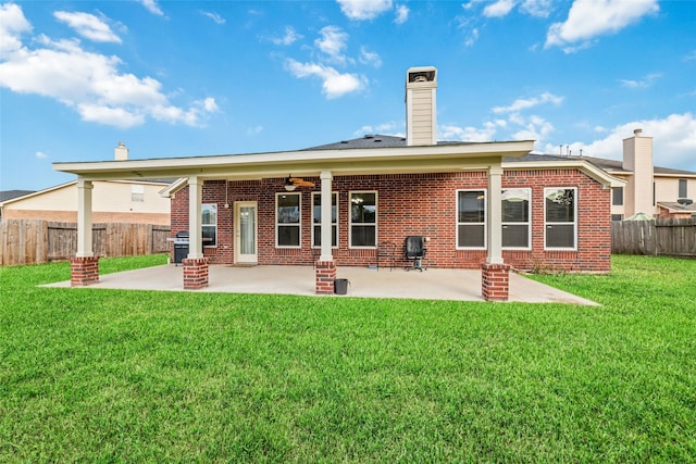 21739 W Mulberry Field Cir, Cypress, TX 77433 - rear view of property with brick siding, a patio area, ceiling fan, a fenced backyard, and a chimney