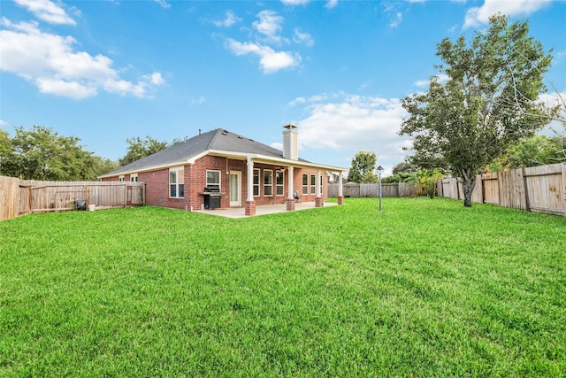21739 W Mulberry Field Cir, Cypress, TX 77433 - back of property with a chimney, a patio area, brick siding, and a fenced backyard