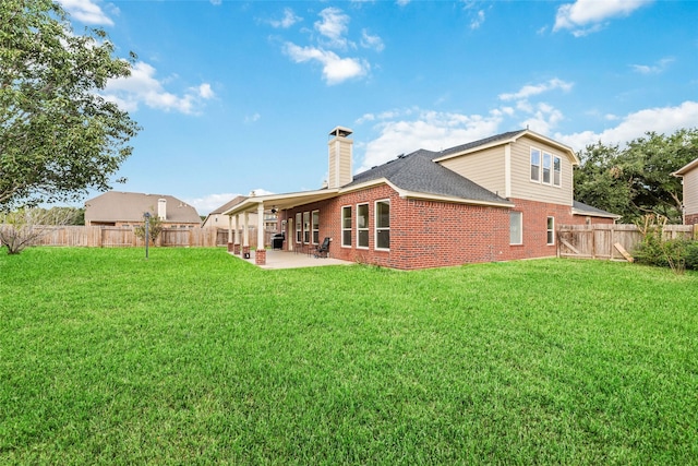 21739 W Mulberry Field Cir, Cypress, TX 77433 - back of house with brick siding, a patio, a fenced backyard, a chimney, and roof with shingles