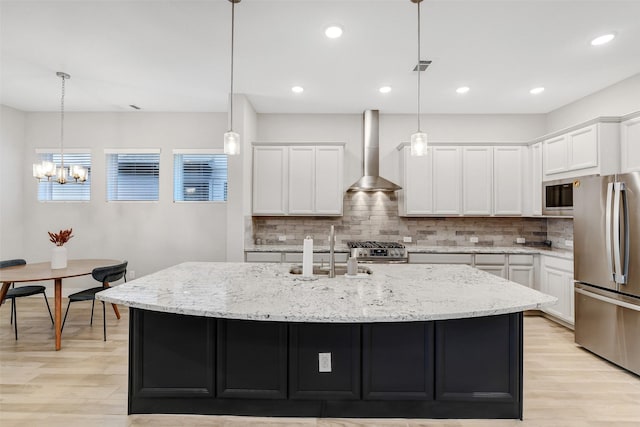 18519 Parkland Row Dr, Cypress, TX 77433 - kitchen featuring stainless steel appliances, wall chimney exhaust hood, backsplash, a chandelier, and white cabinets