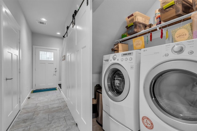 3009A Bell St, Houston, TX 77003 - laundry area featuring independent washer and dryer, light tile patterned floors, a barn door, and recessed lighting