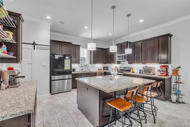 3009A Bell St, Houston, TX 77003 - kitchen featuring stainless steel appliances, crown molding, dark brown cabinetry, backsplash, and a kitchen island