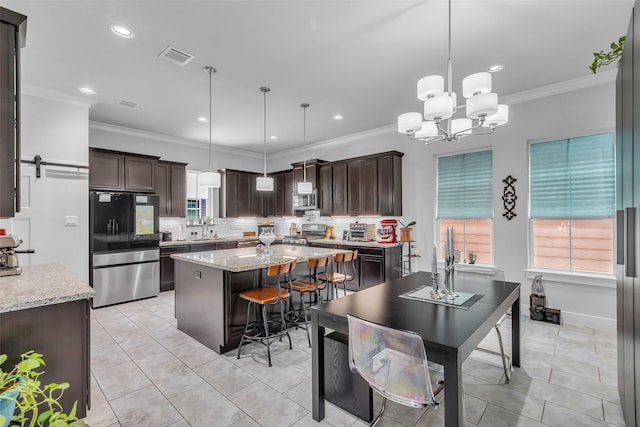 3009A Bell St, Houston, TX 77003 - kitchen with stainless steel appliances, dark brown cabinetry, ornamental molding, decorative backsplash, and a kitchen island