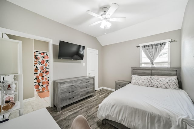 30806 Meadow Wood Dr, Fulshear, TX 77441 - bedroom featuring wood finished floors, vaulted ceiling, and a ceiling fan