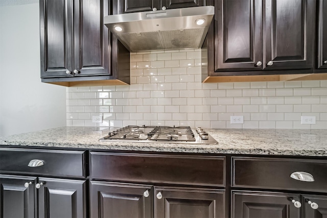 30806 Meadow Wood Dr, Fulshear, TX 77441 - kitchen with ventilation hood, stainless steel gas cooktop, dark brown cabinets, and decorative backsplash