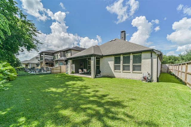 30806 Meadow Wood Dr, Fulshear, TX 77441 - back of property with a fenced backyard, a chimney, a patio area, brick siding, and roof with shingles