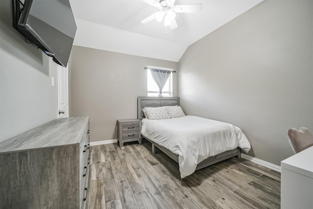 30806 Meadow Wood Dr, Fulshear, TX 77441 - bedroom with light wood-type flooring, vaulted ceiling, and ceiling fan