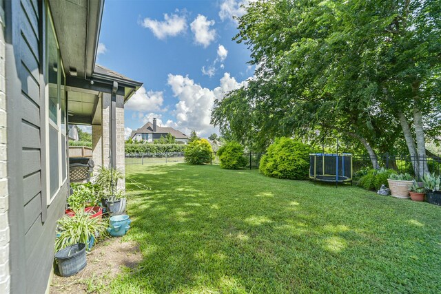 30806 Meadow Wood Dr, Fulshear, TX 77441 - fenced backyard featuring a trampoline