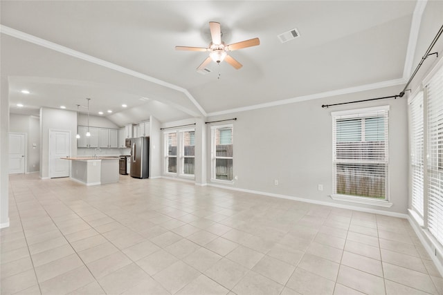 31222 S Pinebrook Falls Ln S, Hockley, TX 77447 - unfurnished living room with vaulted ceiling, light tile patterned floors, ceiling fan, ornamental molding, and recessed lighting