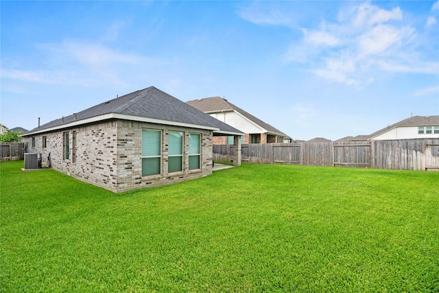31222 S Pinebrook Falls Ln S, Hockley, TX 77447 - back of house with a fenced backyard, brick siding, and roof with shingles