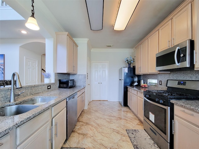 11811 Champions Grove Ln, Houston, TX 77066 - kitchen featuring stainless steel appliances, tasteful backsplash, crown molding, hanging light fixtures, and light stone countertops