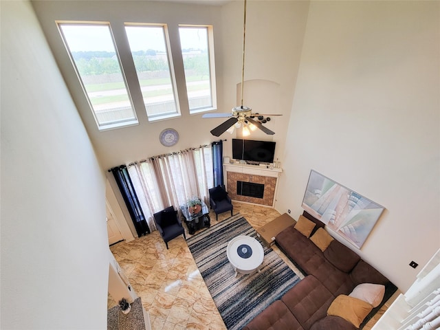 11811 Champions Grove Ln, Houston, TX 77066 - living room featuring marble tiled floors, a high ceiling, a tile fireplace, and a ceiling fan