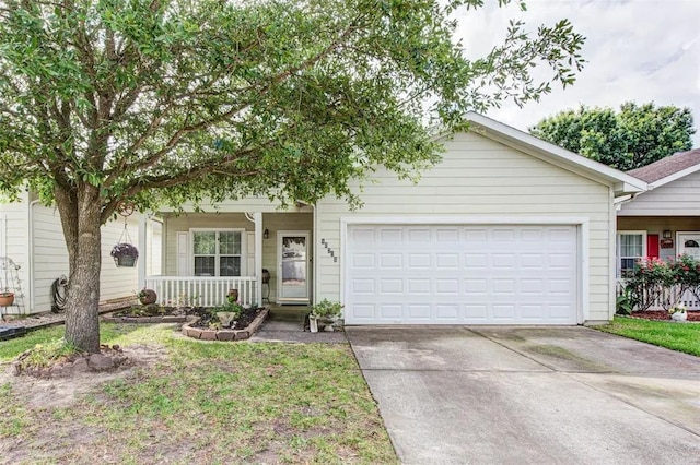 10215 Cinnaberry Ln, Tomball, TX 77375 - view of front of property featuring an attached garage, concrete driveway, and covered porch