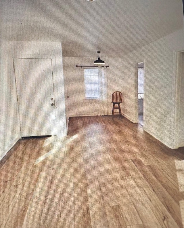 7005 Kassarine Pass, Houston, TX 77033 - empty room with healthy amount of natural light and wood finished floors