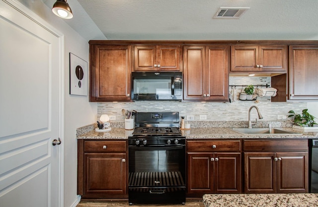 14746 Jasper Stream Ct, Houston, TX 77069 - kitchen featuring black appliances, backsplash, and light stone countertops