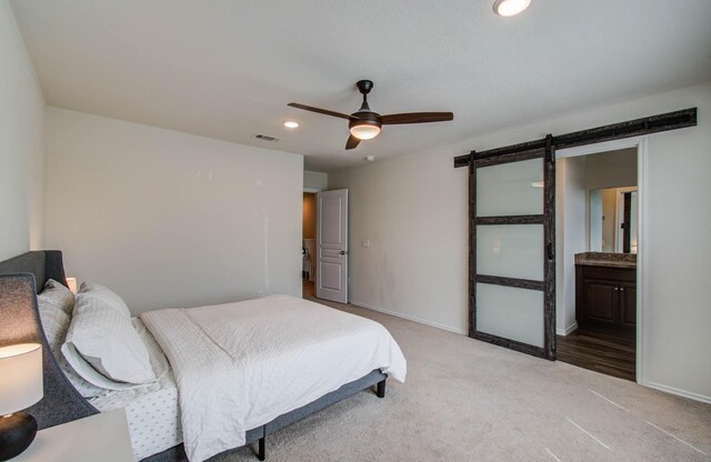 14746 Jasper Stream Ct, Houston, TX 77069 - bedroom featuring light colored carpet, a barn door, recessed lighting, a ceiling fan, and connected bathroom