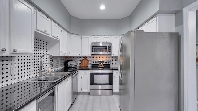 2608 Bering Dr Unit 2608, Houston, TX 77057 - kitchen featuring stainless steel appliances, beverage cooler, dark countertops, backsplash, and white cabinets